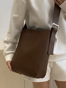 Minimalist brown bucket shoulder bag with adjustable wide strap for women commute