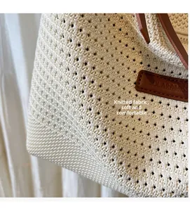 Detailed macro view of the cream woven knit tote bag showing intricate crochet texture
