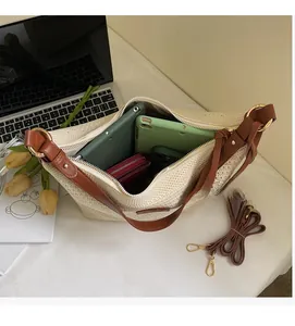 Top view of spacious woven tote bag interior holding tablet, phone, and wallet for daily use