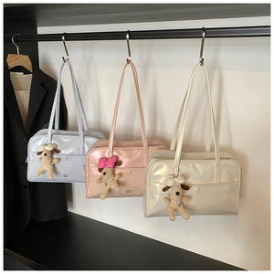 Detailed display of three shiny pillow tote bags in pastel colors with cute puppy charms