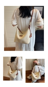 Detailed weave pattern of cream straw tote with leather strap and cute bear charm