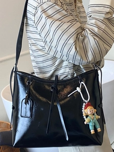 2025 trendy black oil wax leather shoulder bag with wide strap and doll pendant accessory