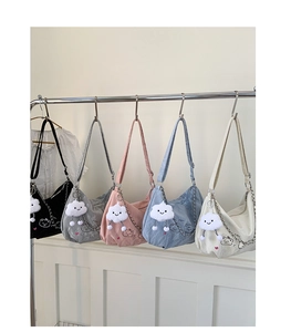 Detail of five colorful hobo shoulder bags with cute cartoon bear prints and cloud pendants