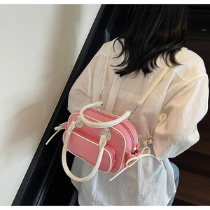 Detail of pink and white vintage backpack with decorative side bows and leather texture