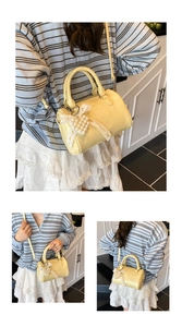 Macro detail of the yellow leather crossbody bag featuring pearl lace bow accessories