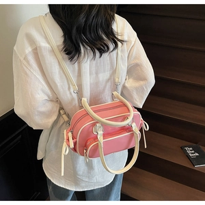 Pink and white bowling-style backpack with long straps shown on a model's back