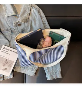 Blue and white striped canvas tote bag showing spacious interior with daily essentials