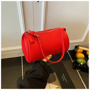 Chic red cylindrical pillow bag in lychee pattern leather with stylish knot zipper detail