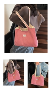 Detail of red and white striped tote bag showing thick beige canvas straps and WEGOCO label