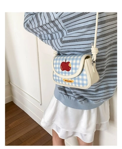 Close-up of blue gingham square bag with red apple embroidery and Not Anxious text