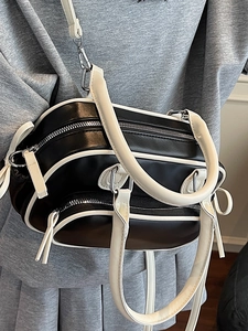 Minimalist black and white contrast boston bag with dual handles and crossbody strap