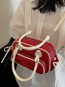 Red and cream vintage bowling style handbag with multi-zipper pockets and silver hardware