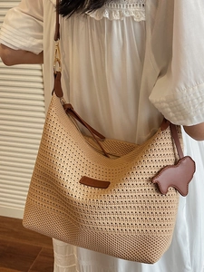 Chic beige straw woven tote bag with brown leather straps and cute bear charm decoration