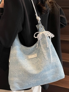 Light blue denim hobo bag with sparkling rhinestones and lace pearl bow charm
