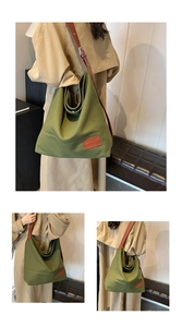 Detail of dark green canvas hobo bag with leather strap and fashion label stitching