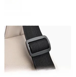 Detail of adjustable black nylon shoulder strap and matte buckle on a minimalist bag