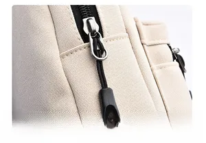 Detail of high-density beige fabric texture with a black smooth metal zipper and cord pull