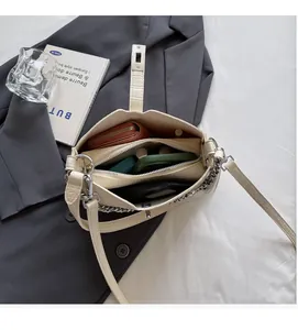 Interior view of beige crocodile embossed crossbody bag with spacious compartments