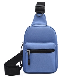 Detailed shot of durable blue canvas sling bag with black adjustable strap and sturdy buckles