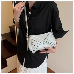 Detail view of white punk chic underarm bag with silver rivets and sleek PU texture