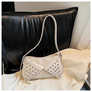 Detail view of cream white shoulder bag featuring silver rivets and glossy PU leather finish