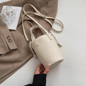 Macro detail of cream white lychee texture bucket bag with drawstring closure