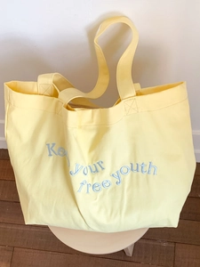 Minimalist creamy yellow canvas tote bag with blue Keep your free youth embroidery
