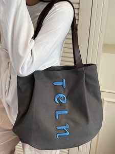 Large dark grey canvas tote bag with blue telm embroidery and brown leather straps