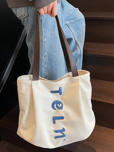 Large capacity off-white canvas tote bag with brown straps and blue telm embroidery