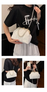 Detailed views of white pleated evening bag with sparkling rhinestones and pearl handle
