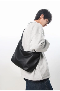 Lifestyle view of a large black matte tote bag showing its natural drape and soft texture