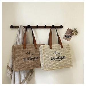Detail showing handwoven summer tote bags with coconut tree patterns and leather handles