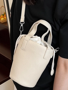 Chic cream mini bucket bag with lychee grain leather and drawstring closure