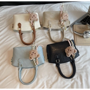 Top view of bucket bags in four colors with crocodile texture and plush bear charms