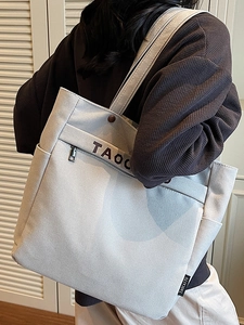 Large capacity canvas tote bag with multi-pocket design and stylish shoulder strap for women