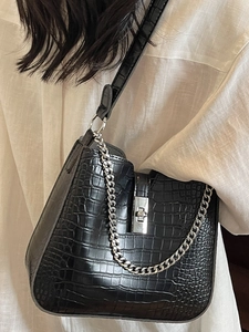 Minimalist black crocodile pattern crossbody bag with silver chain and metal twist lock