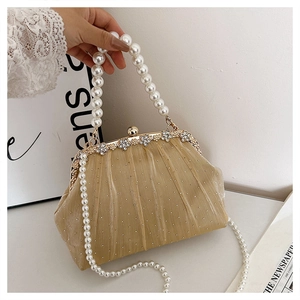 Detail of evening clutch with pleated fabric, rhinestones, and elegant faux pearl handle