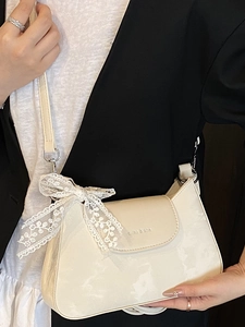 Chic cream white leather shoulder bag with delicate lace bow and silver metal chain