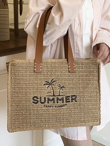 Woven straw summer tote bag with palm tree print and brown leather straps for travel