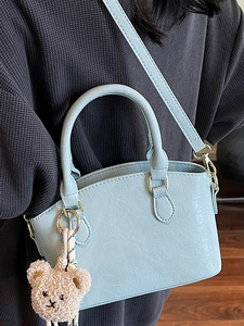 Fashionable light blue crocodile embossed bucket bag with a cute bear plush pendant