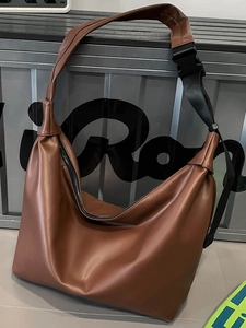 Brown large capacity tote bag with adjustable wide black strap for daily commute use
