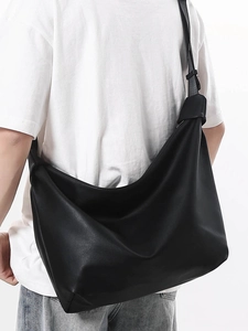 Minimalist black leather tote bag for women with a large capacity and wide strap