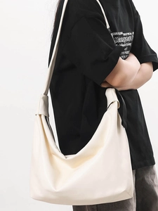 Minimalist large off-white leather hobo bag with wide shoulder strap for women