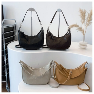 Detailed display of hobo shoulder bags in black, dark brown, beige, and yellow leather