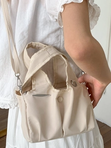 Fashionable beige nylon tote bag with pleated design and adjustable shoulder strap for women