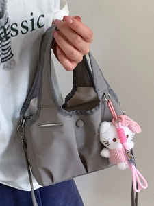 Fashionable grey high-capacity tote bag with dual handles and pink plush keychain