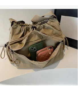 Internal view of khaki shoulder bag showing interior zipper pocket and spacious storage