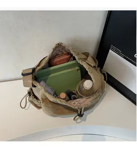Interior view showing the large capacity of the khaki drawstring tote bag with daily items