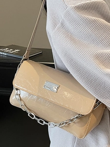 Chic beige pleated patent leather baguette bag with thick silver chain detail