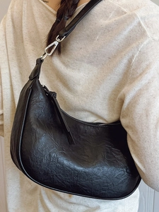 Minimalist black crescent shoulder bag in textured faux leather for summer daily wear
